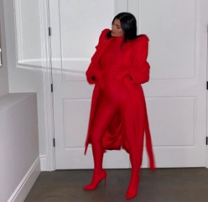 Kylie Jenner displays growing baby bump in red figure-hugging bodysuit (photos)